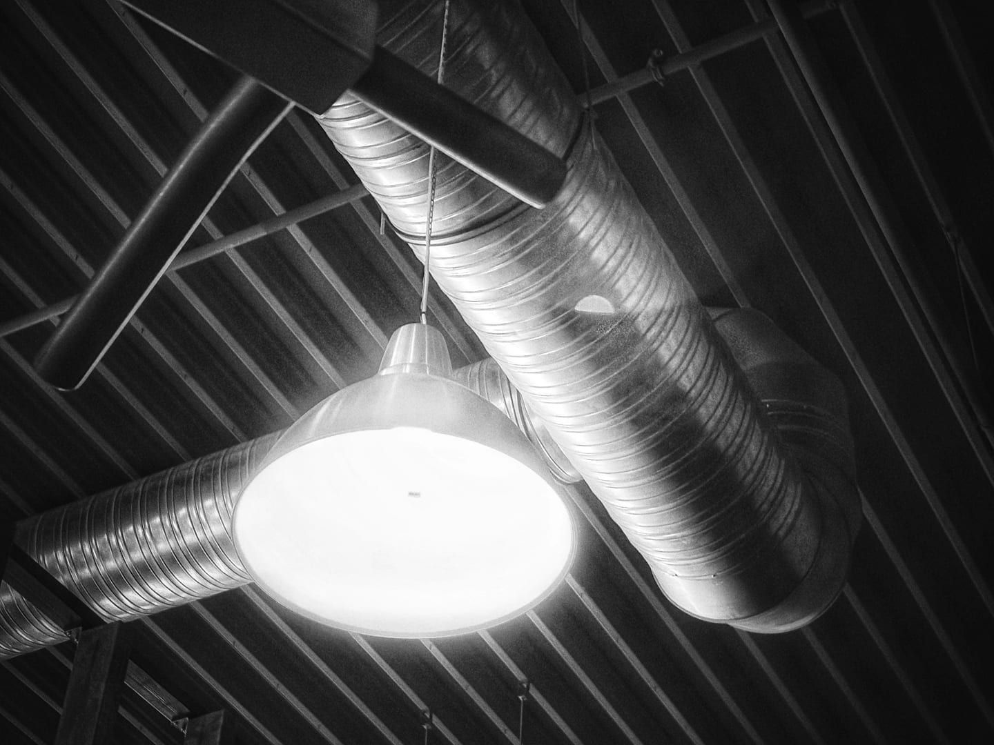 A ductless mini-split head beside a central ducted air handler